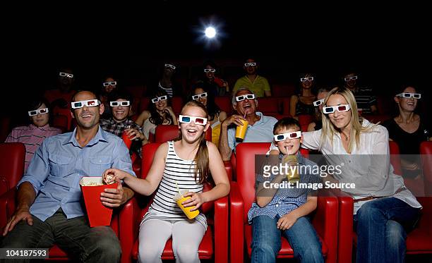 family watching 3d movie at the movie theater - theatre audience stock pictures, royalty-free photos & images