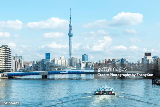 tokyo cityscape over the sumida river with tokyo sky tree and kiyosu bridge and cruise at day time, tokyo, japan. - tokyo skyline stock-fotos und bilder