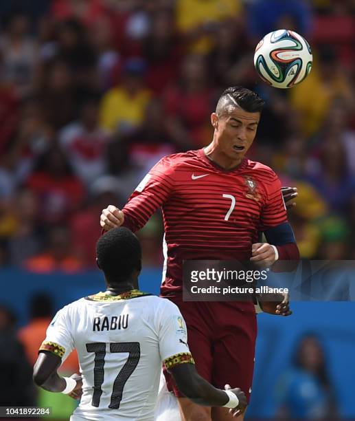 Mohammed Rabiu of Ghana in action against Cristiano Ronaldo of Portugal during the FIFA World Cup 2014 group G preliminary round match between...