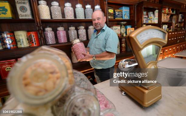 Museum leader Juergen Hein stands in a former Tante Emma Laden in the Bonbon Museum in Kleinglattbach, Germany, 20 August 2013. Photo: FRANZISKA...