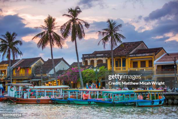 june 2017 hoi an, vietnam - local river boats sit along the banks of the thu bon river in hoi an. - hoi an stockfoto's en -beelden