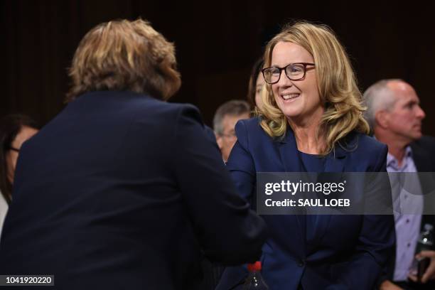 Christine Blasey Ford , the woman accusing Supreme Court nominee Brett Kavanaugh of sexually assaulting her at a party 36 years ago, shakes hands...