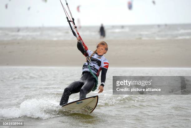 Ninefold kitesurf world champion Kristin Boese of Germany drives with a mask of chancellor Merkel at the Kitesurf World Cup 2013 in St. Peter-Ording,...