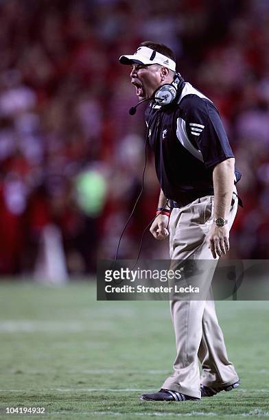 Head coach Butch Jones of the Cincinnati Bearcats yells at his team against the North Carolina State Wolfpack during their game at Carter-Finley...
