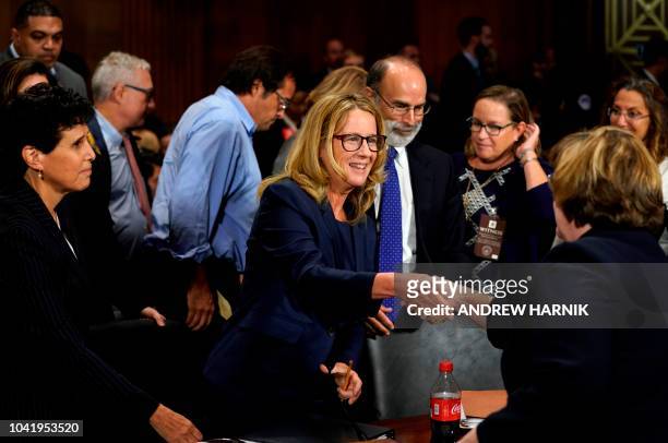 Christine Blasey Ford shakes hands with Phoenix prosecutor Rachel Mitchell as she finished testifying before the Senate Judiciary Committee on...