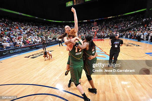 Sue Bird, Lauren Jackson and Swin Cash of the Seattle Storm celebrates after defeating the Atlanta Dream in Game Three of the 2010 WNBA Finals on...