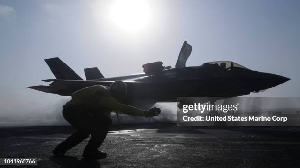 5th FLEET AREA OF OPERATIONS U.S. Navy Petty Officer 1st Class Rey White, an aviation boatswains mate handler with the Essex Amphibious Ready Group ,...