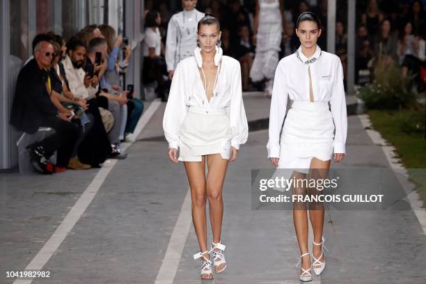 Model Bella Hadid and US model Kendall Jenner present creations by Off-White during the Spring-Summer 2019 Ready-to-Wear collection fashion show in...