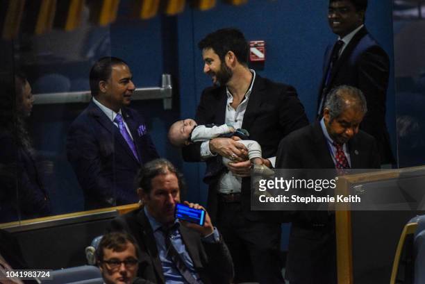 While Jacinda Ardern, Prime Minister of New Zealand delivers a speech at the United Nations her partner Clarke Gayford holds their baby Neve during...