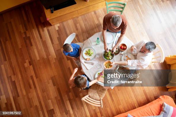 lgbtq family eating together - kitchen hardwood floor stock pictures, royalty-free photos & images