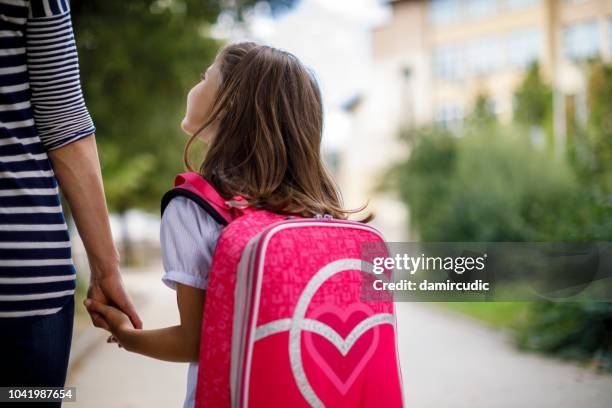 mother taking her daughter to school - child rucksack stock pictures, royalty-free photos & images