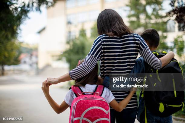 mother taking kids to school - child rear view stock pictures, royalty-free photos & images