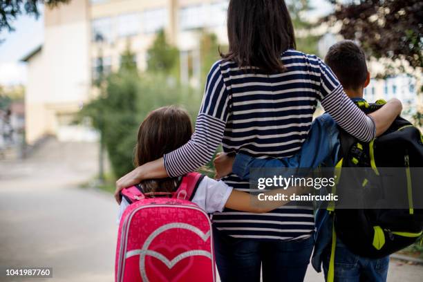 mother taking kids to school - separation anxiety stock pictures, royalty-free photos & images