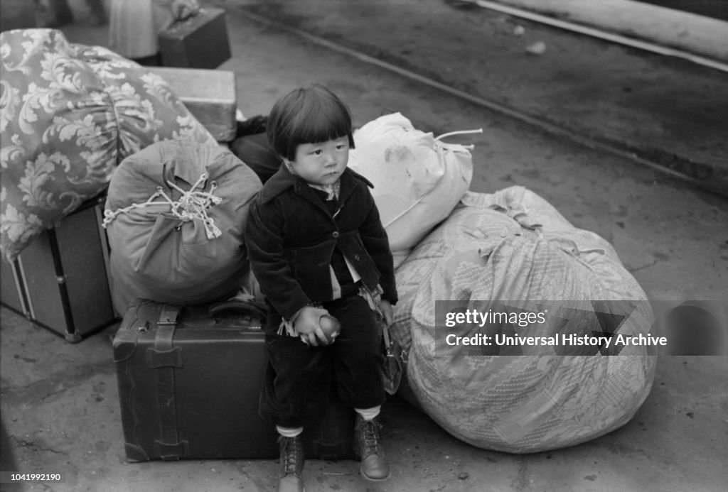 Japanese-American Child Waiting for Train to Owens Valley During Evacuation under US Army War Emergency Order, Los Angeles