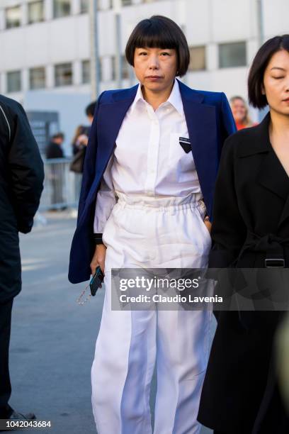 Angelica Cheung, wearing a white shirt, white pants and blue blazer, is seen after the Chloe show on September 27, 2018 in Paris, France.