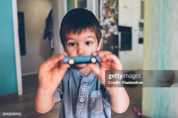 boy playing with toy car - boys toys stock pictures, royalty-free photos & images