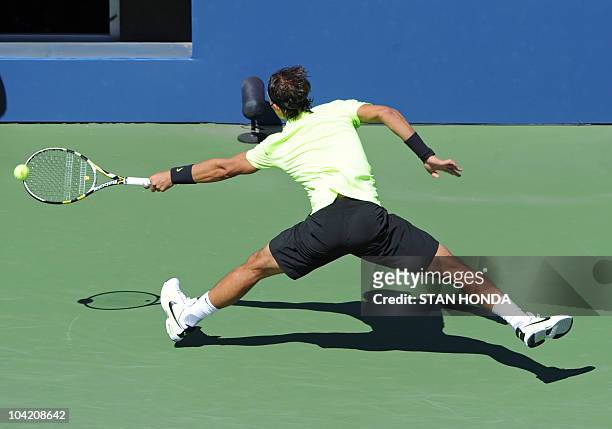 Rafael Nadal of Spain returns a shot to Mikhail Youzhny of Russia in the Men's Semifinals at the US Open 2010 tennis tournament September 11, 2010 in...