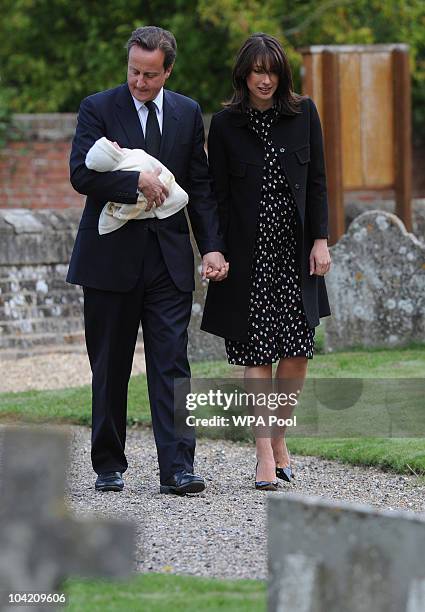Prime Minister David Cameron, his wife Samantha and their baby daughter Florence, arrive at St Barnabas Church for the funeral of his father Ian who...