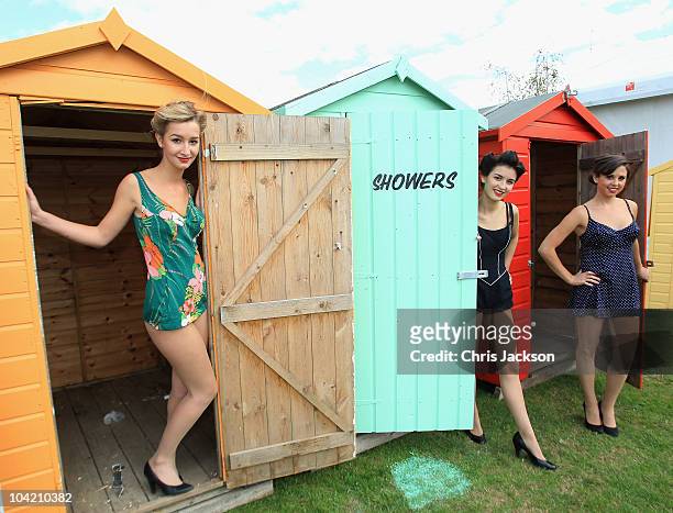 Girls in vintage bikinis pose for a photograph in the driver's enclosure during Goodwood Revival 2010 at Goodwood on September 17, 2010 in...