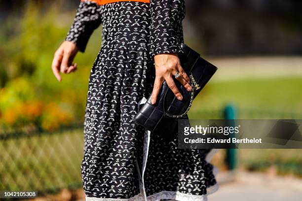 Guest holds a black bag, outside Paco Rabanne, during Paris Fashion Week Womenswear Spring/Summer 2019, on September 27, 2018 in Paris, France.