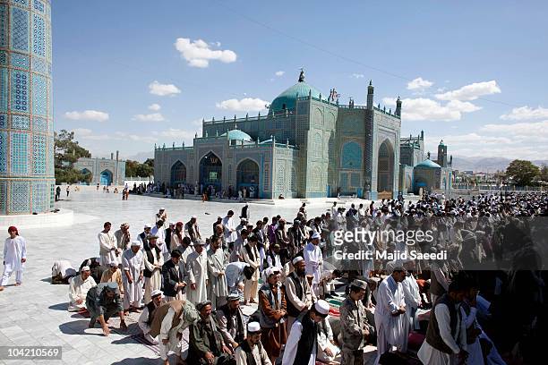 Afghan men pray at the Blue Mosque a day before the parliamentary election September 17, 2010 in Mazar-e-sharif, Afghanistan. Security is of gaining...