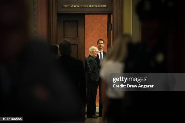 Senate Majority Leader Mitch McConnell and Sen. Tom Cotton await fellow GOP Senators for the start of a closed-door GOP caucus meeting following the...