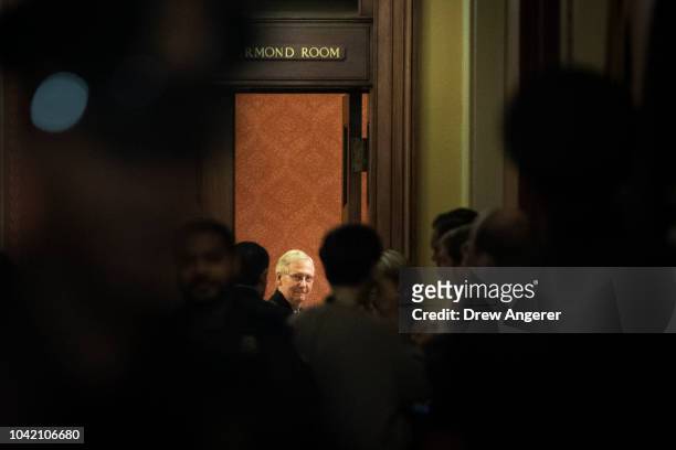Senate Majority Leader Mitch McConnell waits for fellow GOP Senators to arrive at the start of a closed-door GOP caucus meeting following the Senate...