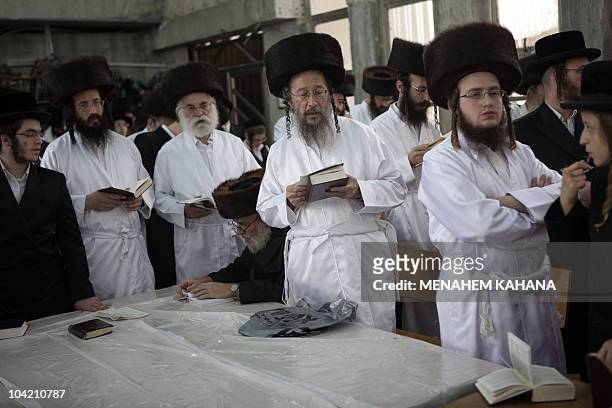 Ultra-Orthodox Jews wear white holiday cloths during noon prayers a few hours before the start of Yom Kippur, the Jewish holy day of Atonement, on...