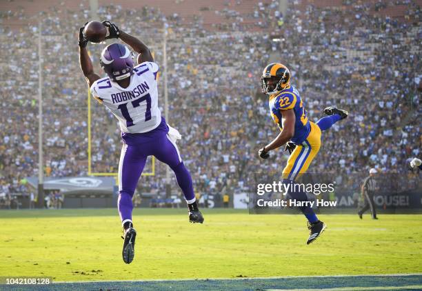 Wide receiver Aldrick Robinson of the Minnesota Vikings makes a catch in front of cornerback Marcus Peters of the Los Angeles Rams to score a...