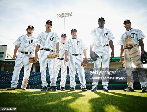 professional baseball players standing on field - baseball jersey stock pictures, royalty-free photos & images