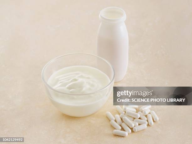 probiotic pills and yoghurt - calcita fotografías e imágenes de stock