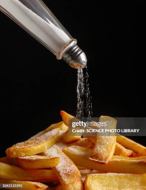 salt pouring onto chips - hypertensive stock pictures, royalty-free photos & images