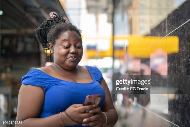 african ethnicity woman using mobile - africa phone black stock pictures, royalty-free photos & images