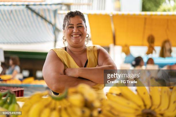 porträt von zuversichtlich besitzer - verkauf von bananen am bauernmarkt - brasilien stock-fotos und bilder