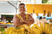 Portrait of confident owner - Selling bananas at farmers market