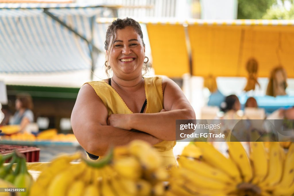 Portrait of confident owner - Selling bananas at farmers market