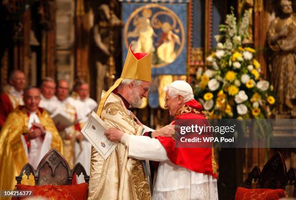 Pope Benedict XVI embraces with the Archbishop of Canterbury Dr Rowan Williams in Westminster Abbey during a service of evening prayer on September...