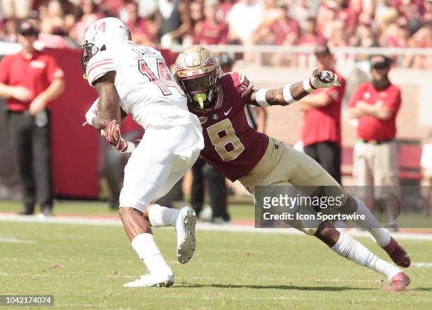 Florida State Seminoles defensive back Stanford Samuels III makes a tackle on Northern Illinois Huskies wide receiver Spencer Tears during the game...