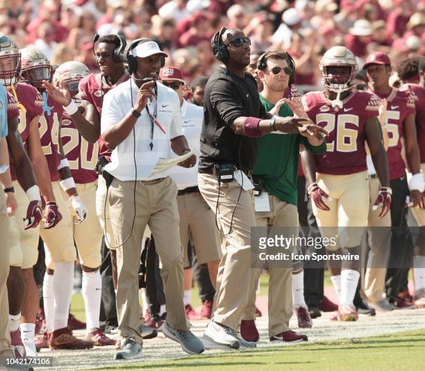 Florida State Seminoles head coach Willie Taggart and Florida State running backs coach Donte' Pimpleton calling plays during the game between the...