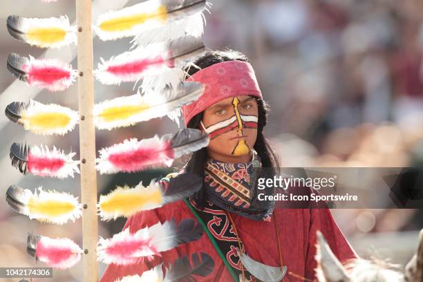 Florida State Seminoles' Chief Osceola looks on while holding the spear while riding Renegade during the game between the Florida State Seminoles and...