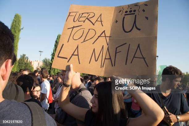 Student seen holding a poster Outside the URJC mafia, during a strike by students of the Rey Juan Carlos University. They were protesting the loss of...