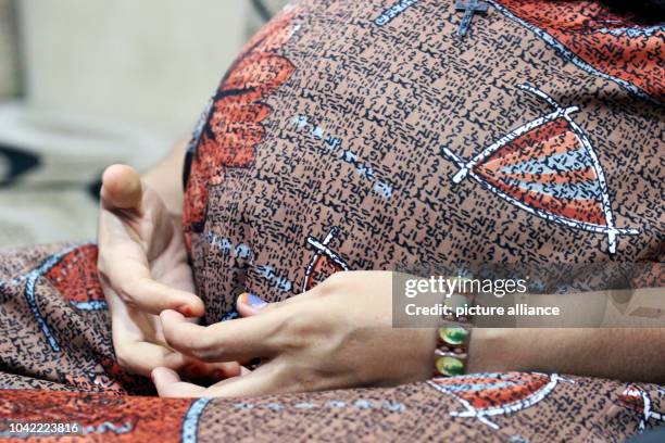 Surrogate mother Arpita Christian sits in a surrogate mother home at the Akanksha Infertility Clinic in Anand, India, 06 May 2014. She is nine months...