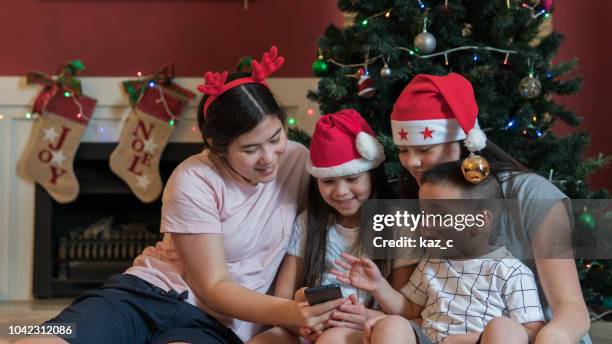 siblings on a video call during christmas - new zealand christmas stock pictures, royalty-free photos & images