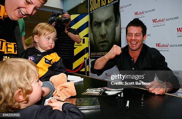 Retired AFL Player Ben Cousins gestures to a young fan as he signs DVDs while promoting his new DVD "Such Is Life - The Troubled Times Of Ben...