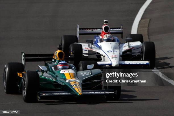 Takuma Sato of Japan, driver of the Lotus-KV Racing Technology Dallara Honda leads Hideki Mutoh of Japan, driver of the Formula Dream/Panasonic...