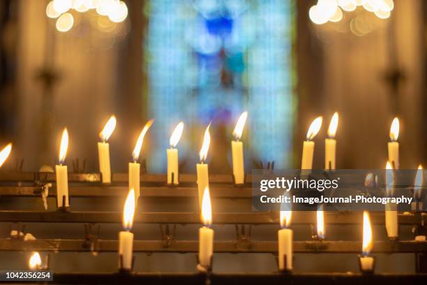 candles for prayers - catholic advent stock pictures, royalty-free photos & images