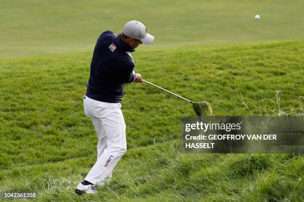 Golfer Jordan Spieth plays a fairway shot during his fourball match on the first day of the 42nd Ryder Cup at Le Golf National Course at...
