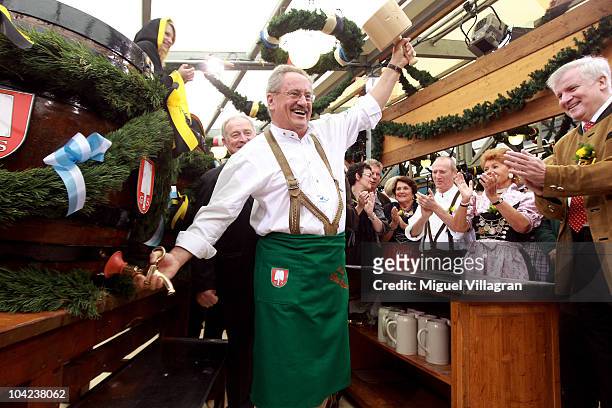 Bavaria's State Premier Horst Seehofer applauds as Munich's mayor Christian Ude opens the first beer barrel to start the Oktoberfest beer festival at...