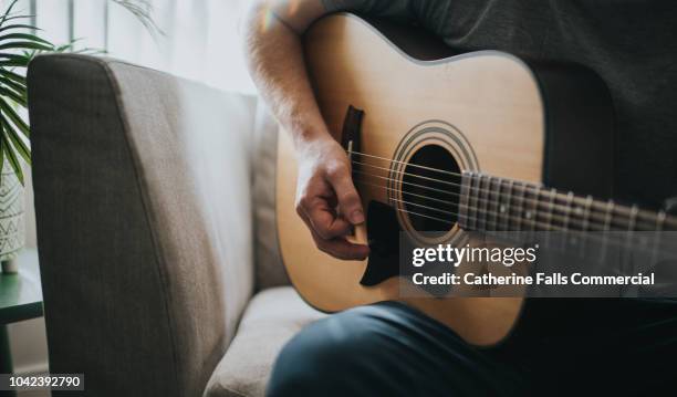 man playing a guitar - serenading stock-fotos und bilder