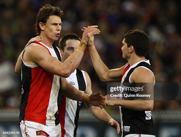 Justin Koschitzke of the Saints is congratulated by team-mates after kicking a goal during the Seecond AFL Preliminary Final match between the St...